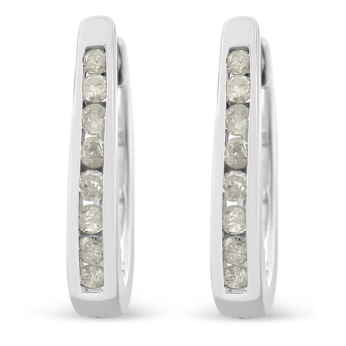 Front-facing close-up of white metal hoop earrings with channel-set round white gemstones.