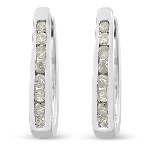 Front-facing close-up of white metal hoop earrings with channel-set round white gemstones.