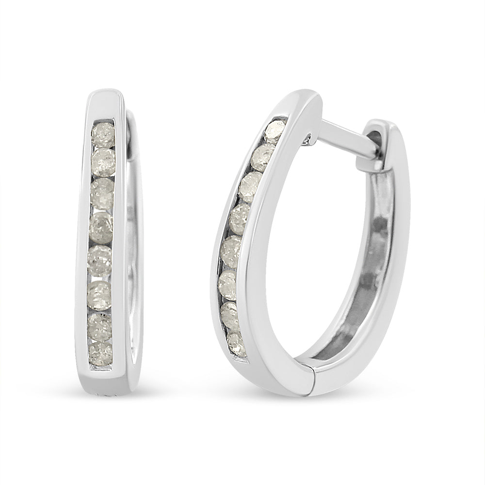 Pair of white metal hoop earrings with round white gemstones set in a channel setting, shown from a front and slight side angle.