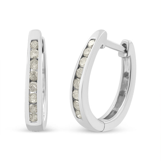 Pair of white metal hoop earrings with round white gemstones set in a channel setting, shown from a front and slight side angle.