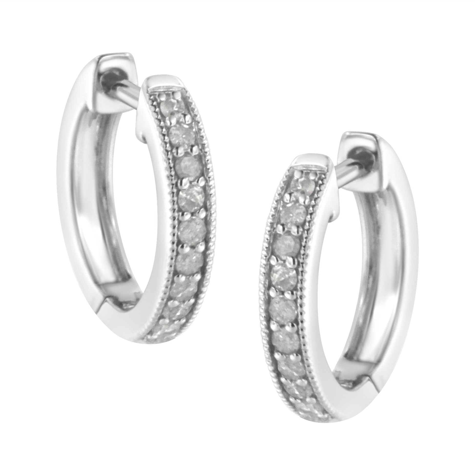 Close-up front angle of a pair of white metal hoop earrings with a row of round white gemstones in prong settings along the outer edge.