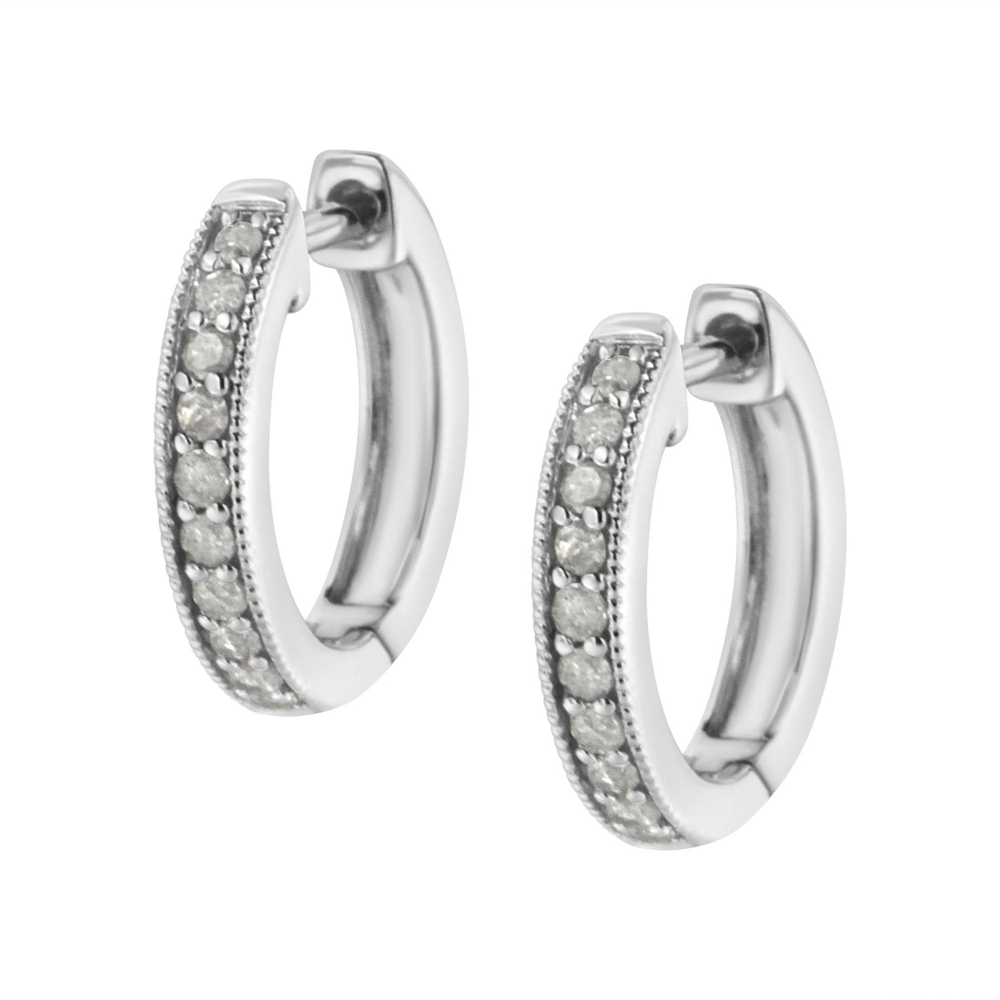 Pair of white metal hoop earrings with round prong-set white gemstones, shown at a slight angle.