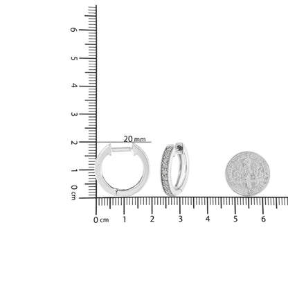 Pair of white metal hoop earrings with prong-set round white gemstones, shown on a ruler and next to a dime for size reference, photographed from the front and side angles.