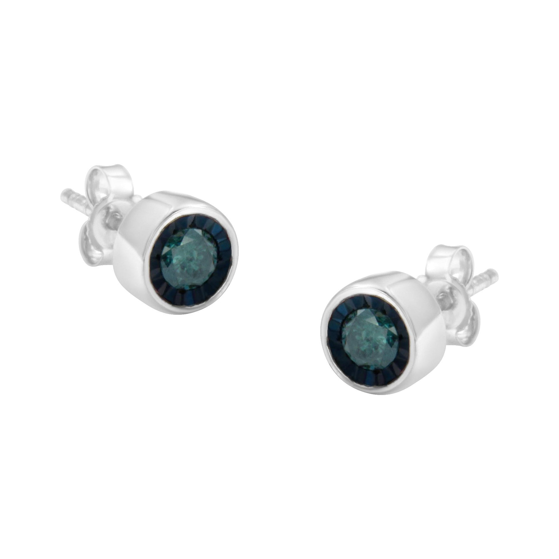 Pair of white metal stud earrings with round blue gemstones in miracle setting, shown at a slight angle.