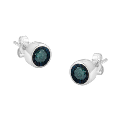 Pair of white metal stud earrings with round blue gemstones in miracle setting, shown at a slight angle.