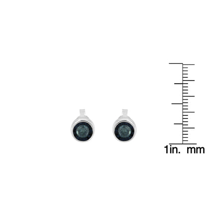 Front view of white metal round stud earrings with blue gemstones, shown next to a ruler for size reference.