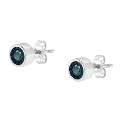 Front angle view of a pair of white metal stud earrings featuring round blue gemstones in miracle settings.