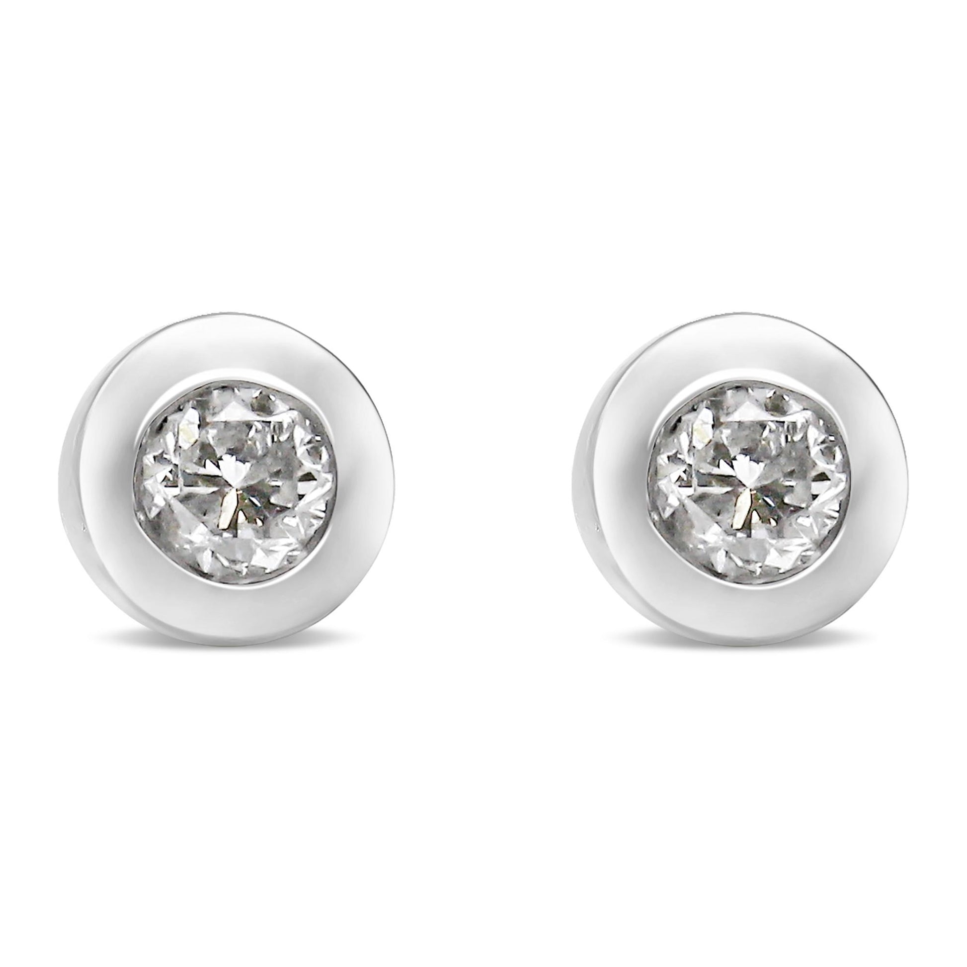 Front-facing view of a pair of white metal round bezel set white gemstone stud earrings.