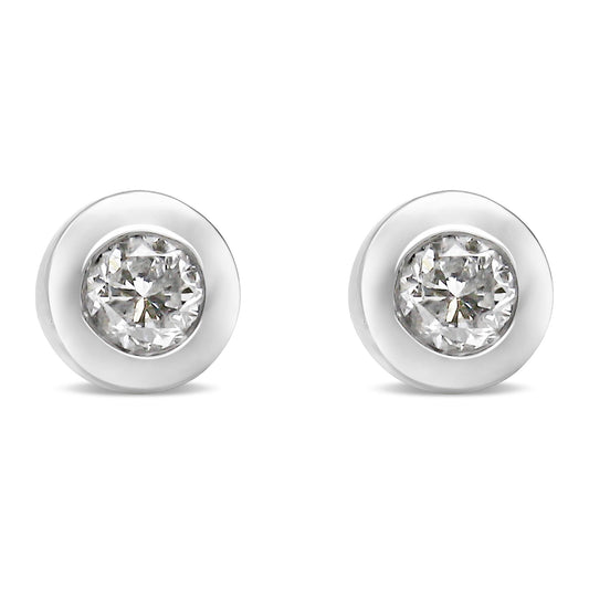 Front-facing view of a pair of white metal round bezel set white gemstone stud earrings.