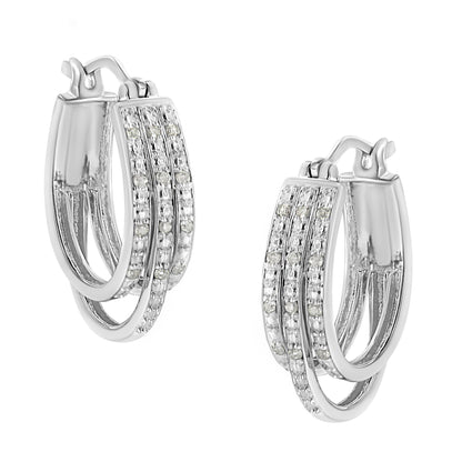 Pair of white metal hoop earrings with three overlapping bands, each set with round white gemstones in a pavé setting, shown at a slight angle.
