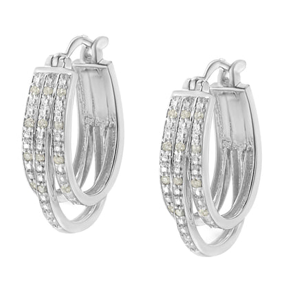 Pair of white metal hoop earrings with three parallel rows of round white gemstones in pavé setting, shown in a front angled close-up view.