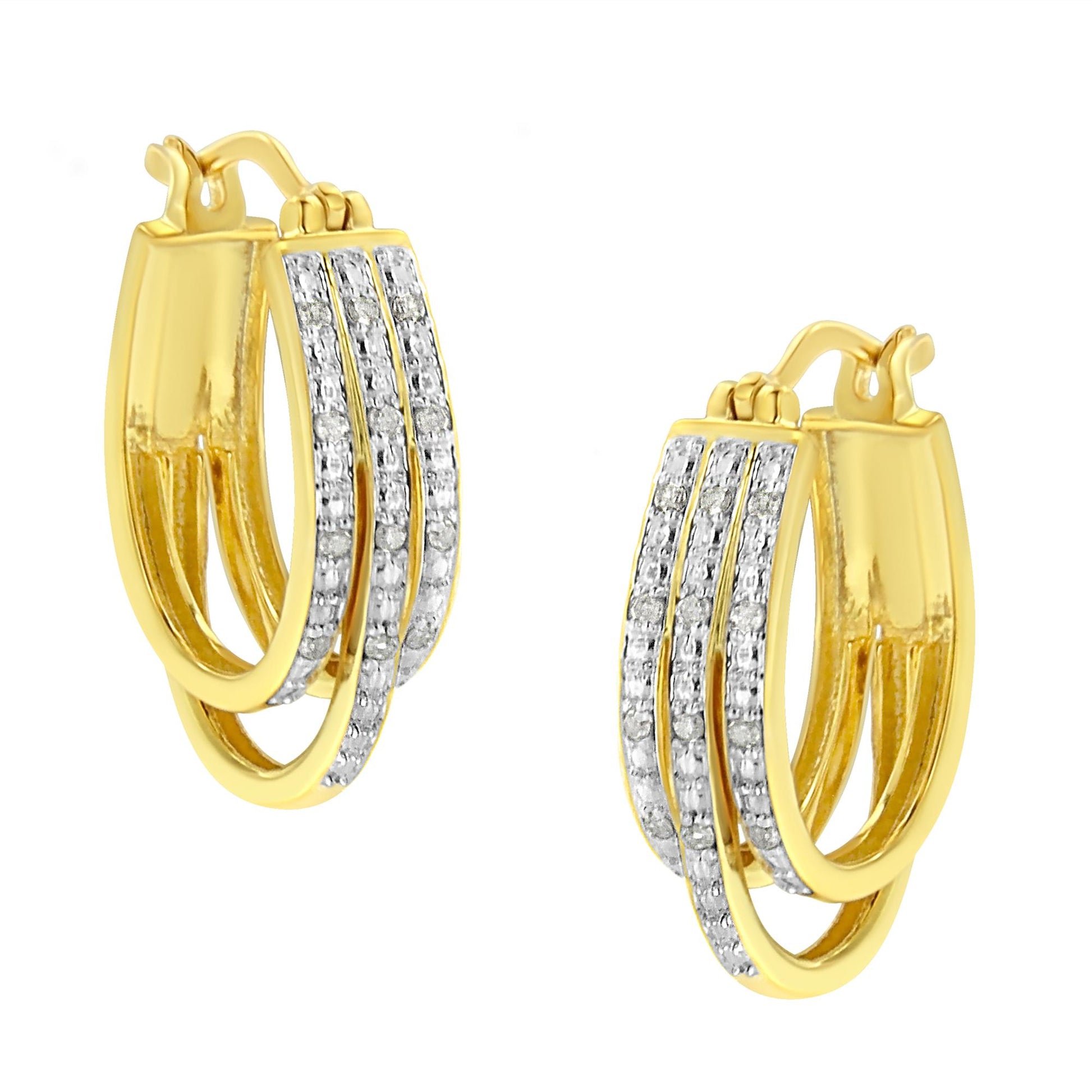 Pair of yellow metal earrings with three rows of white round pave-set gemstones, shown at an angle.