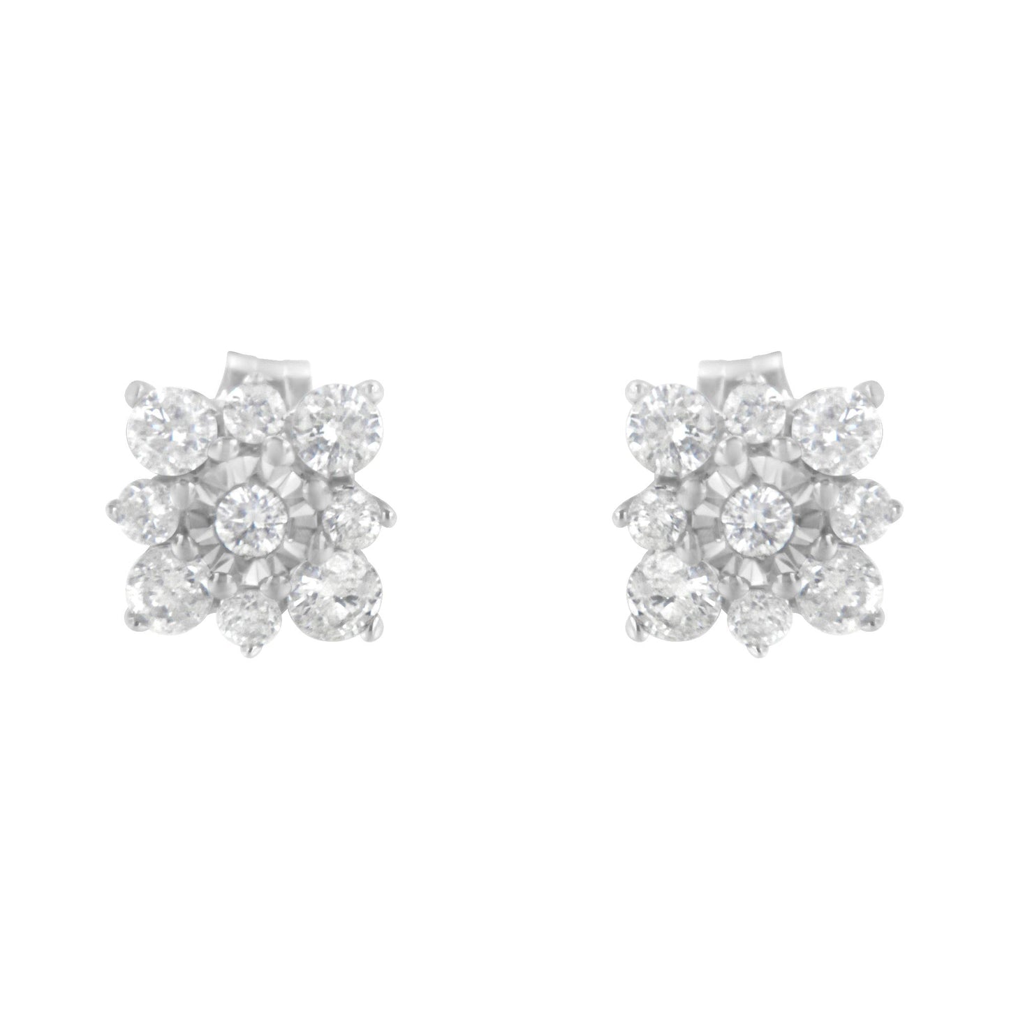 Front angled view of white metal stud earrings featuring multiple round white gemstones in prong and miracle settings arranged in a floral design.
