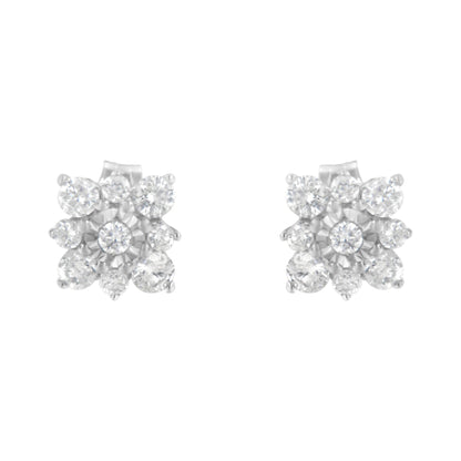 Front angled view of white metal stud earrings featuring multiple round white gemstones in prong and miracle settings arranged in a floral design.