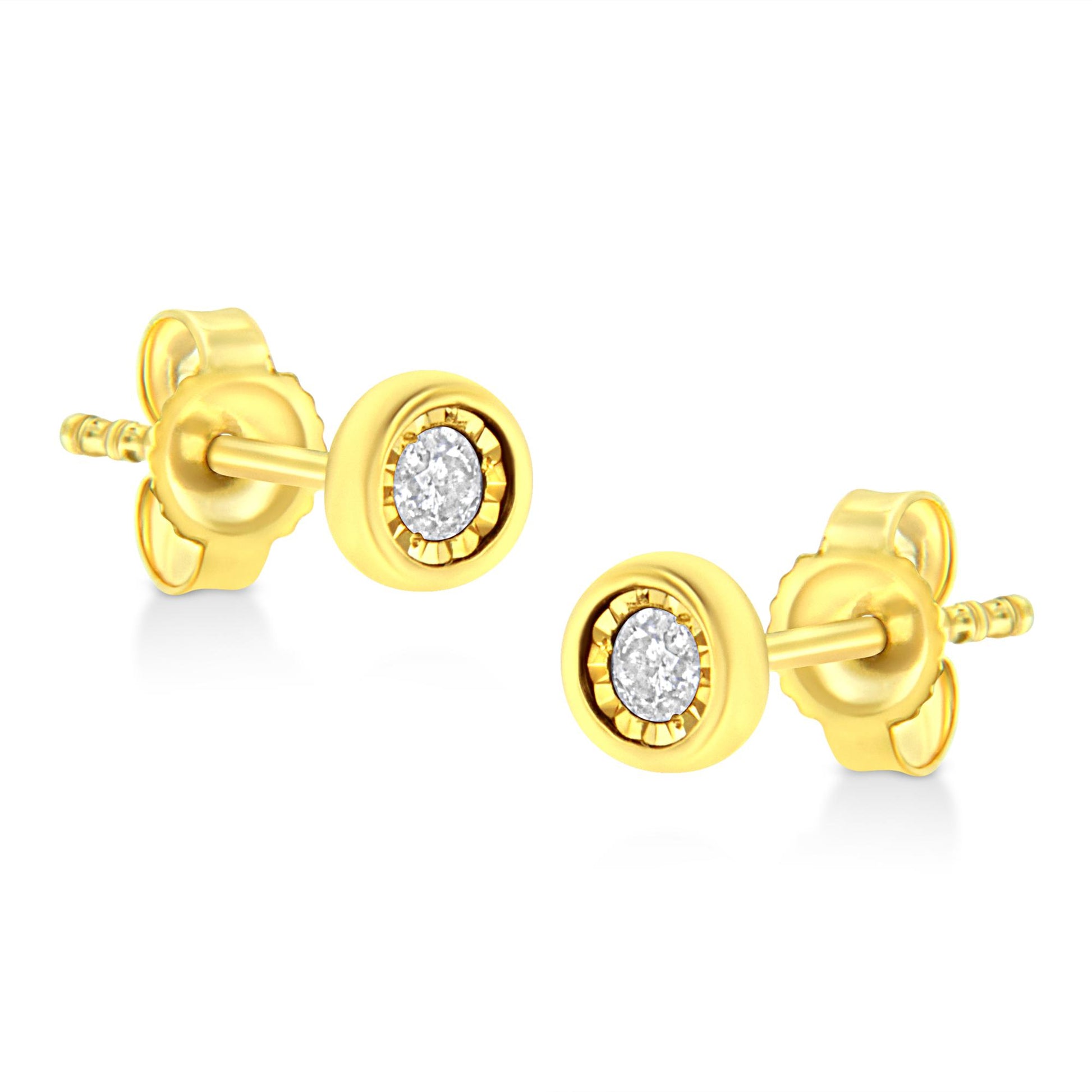 Pair of yellow metal stud earrings with round white gemstones in miracle settings, shown from a side angle.