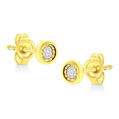 Pair of yellow metal stud earrings with round white gemstones in miracle settings, shown from a side angle.