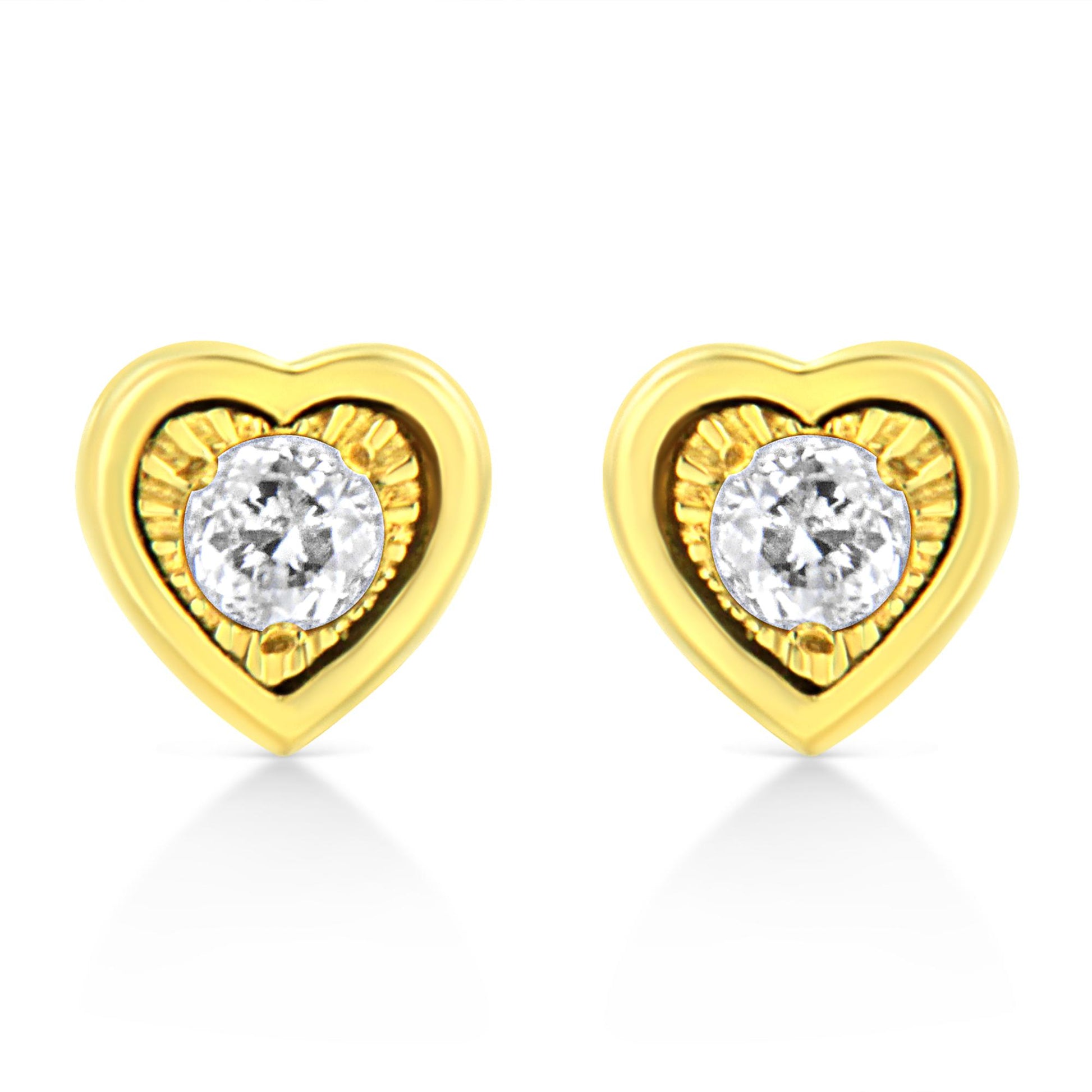 Front-facing shot of yellow metal heart-shaped earrings each set with a round white gemstone in a miracle setting with brownish accents.