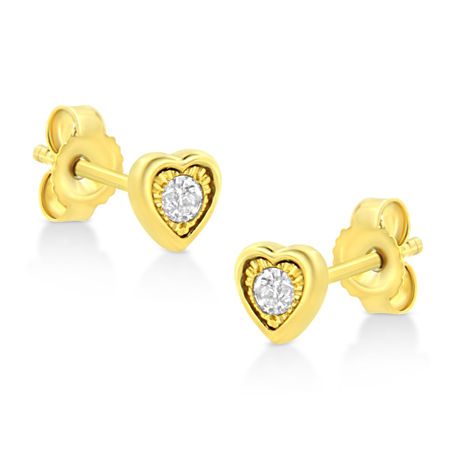 Pair of yellow metal heart-shaped stud earrings with a round white gemstone in the center, shown from an angled front view on a white background.