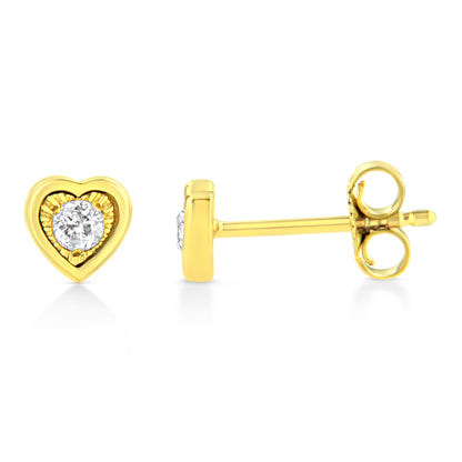 Close-up front and side view of yellow metal heart-shaped stud earrings with round white gemstones in the center.