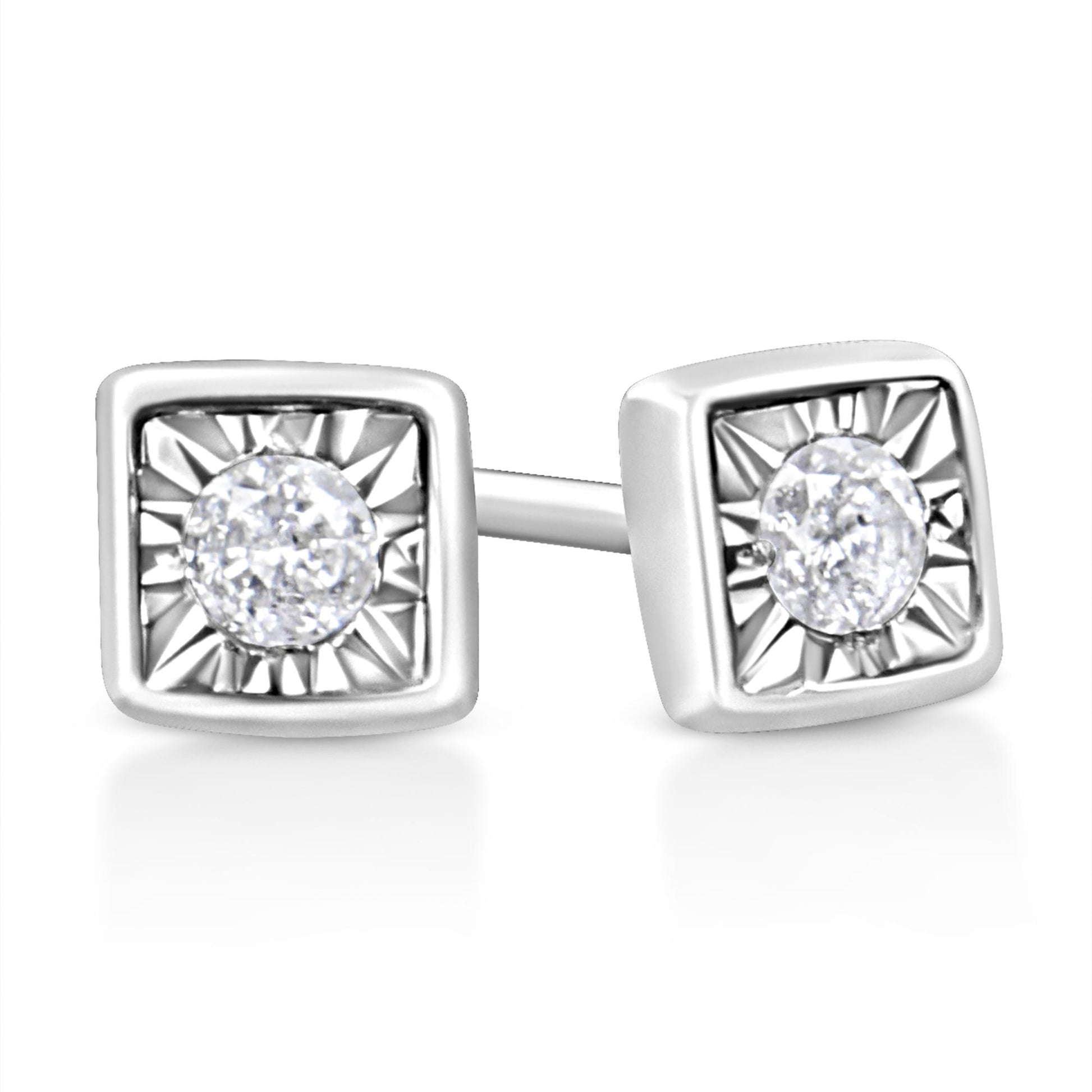 Close-up front angle of white stud earrings with square settings and round white gemstones in the center.