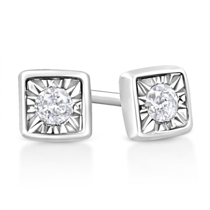 Close-up front angle of white stud earrings with square settings and round white gemstones in the center.