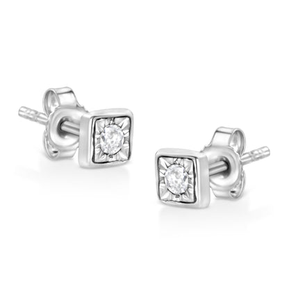 Pair of white metal stud earrings with square frames and round white gemstones set in the center, shown at an angled close-up.