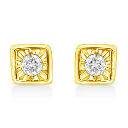Front view of a pair of yellow metal square earrings with a round white gemstone in the center with a radiant pattern around it.