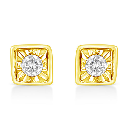 Front view of a pair of yellow metal square earrings with a round white gemstone in the center with a radiant pattern around it.
