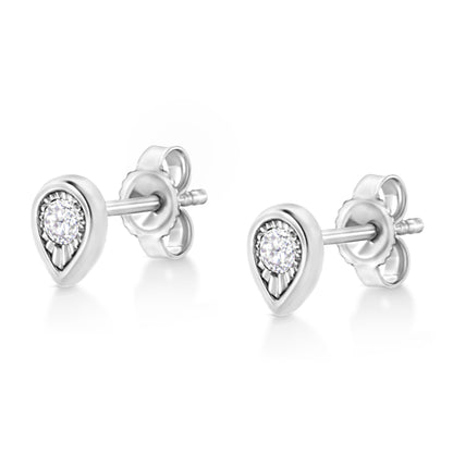 Pair of white metal pear-shaped stud earrings with a round white gemstone in the center, shown from a front side angle.
