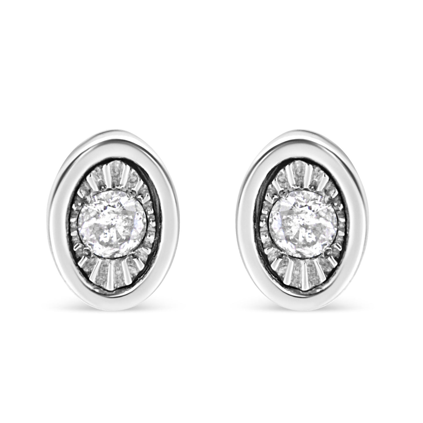 Front view of white metal oval earrings with a central round white gemstone in a miracle setting surrounded by textured detailing.