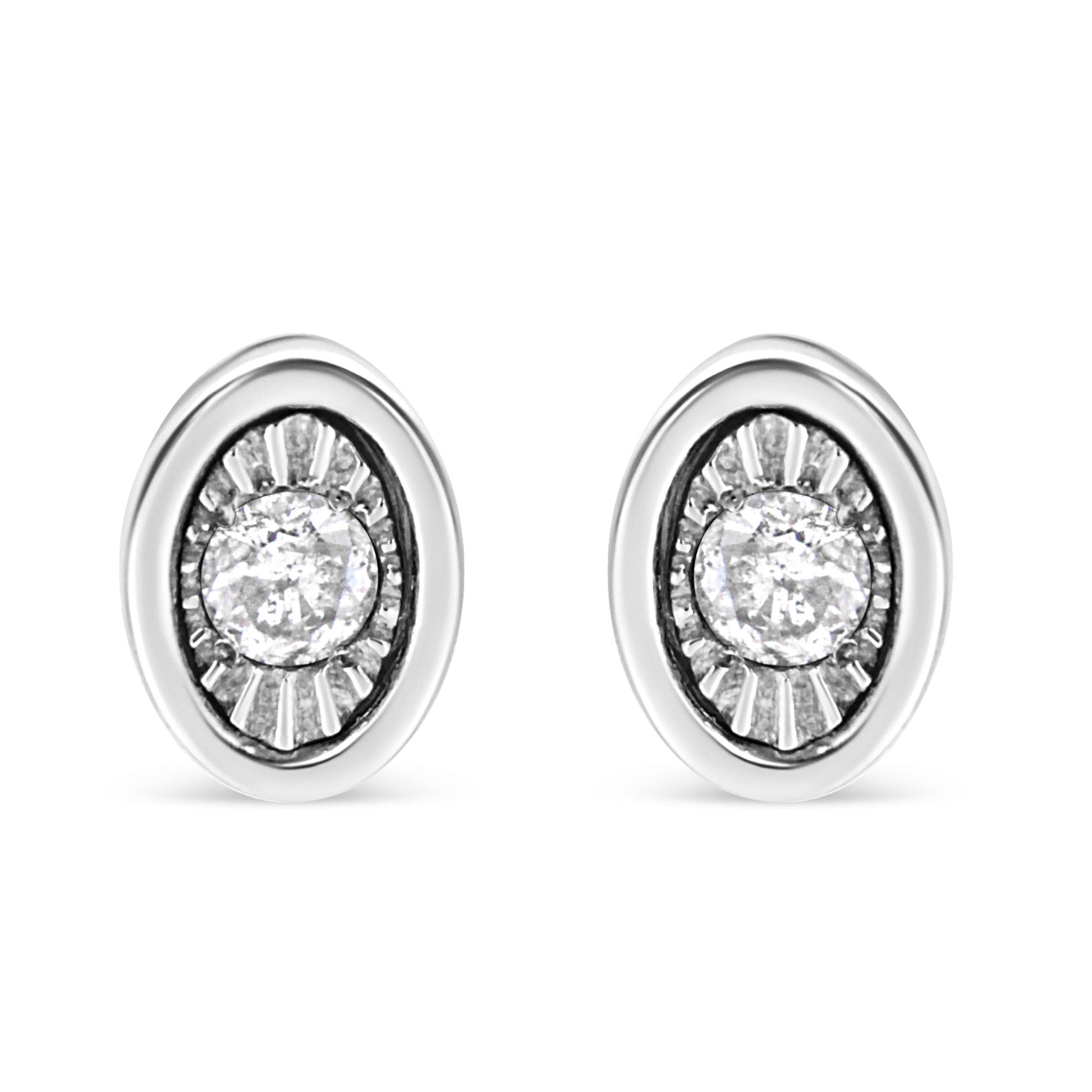 Front view of white metal oval earrings with a central round white gemstone in a miracle setting surrounded by textured detailing.