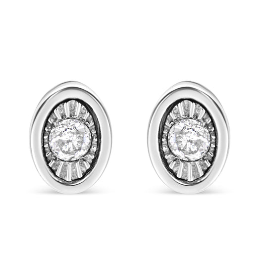Front view of white metal oval earrings with a central round white gemstone in a miracle setting surrounded by textured detailing.