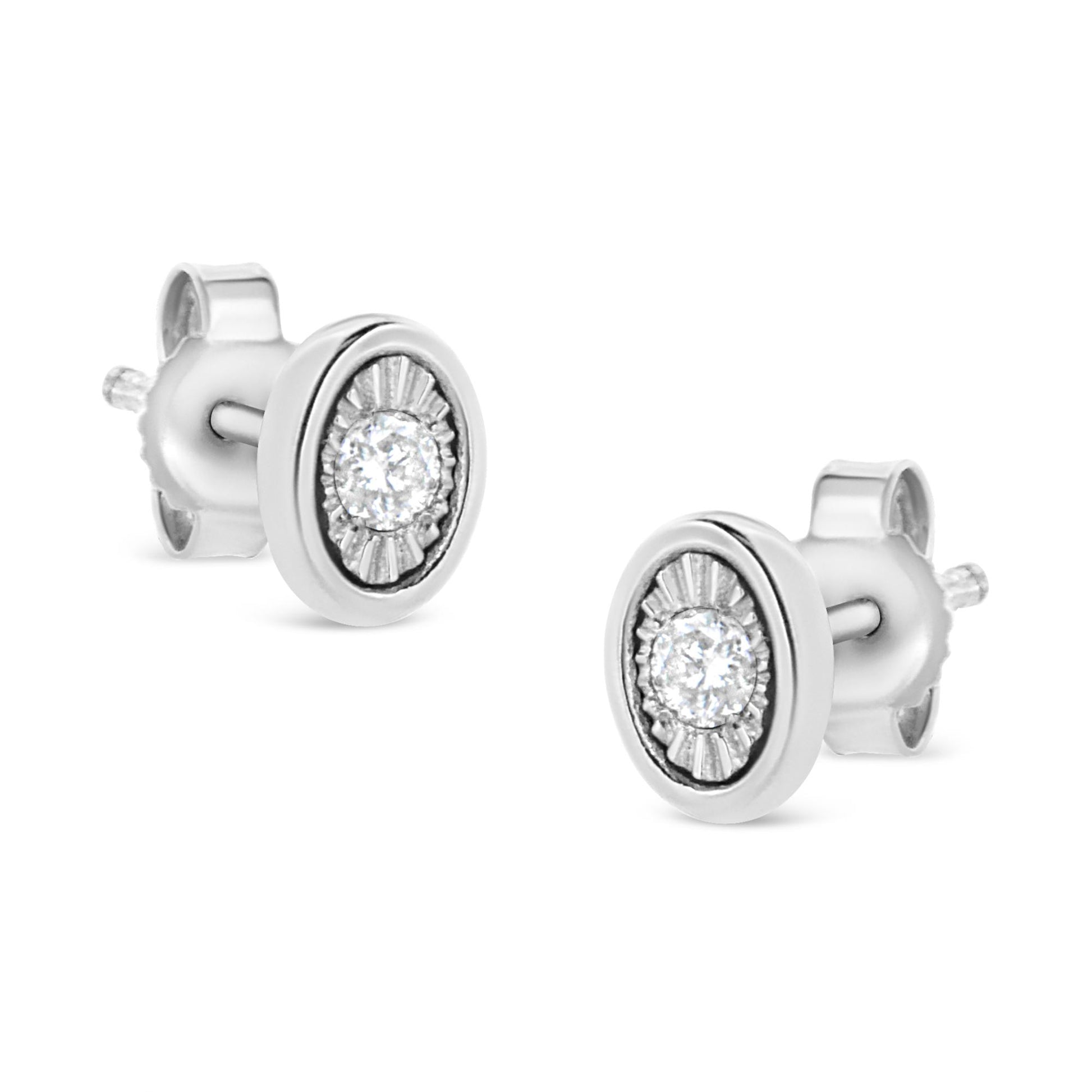 Pair of white stud earrings with round white gemstones set in miracle settings, shown from an angled front view.