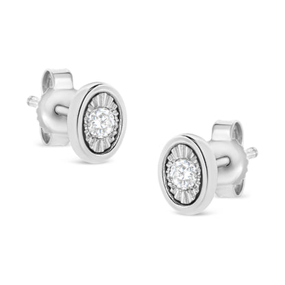 Pair of white stud earrings with round white gemstones set in miracle settings, shown from an angled front view.