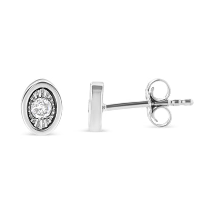 Front and side view of a white metal oval stud earring with a round white gemstone in the center in miracle setting on a white background.