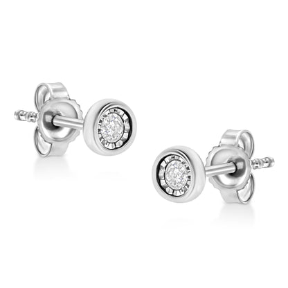 Pair of white metal stud earrings with round white gemstones in miracle setting, shown in close-up angle.