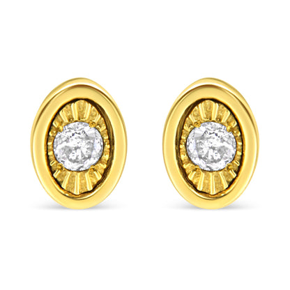 Front view of yellow metal oval earrings, each set with a round white gemstone in miracle setting.