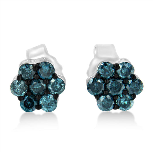 Front-facing close-up of white metal earrings with round blue gemstones in a cluster design.