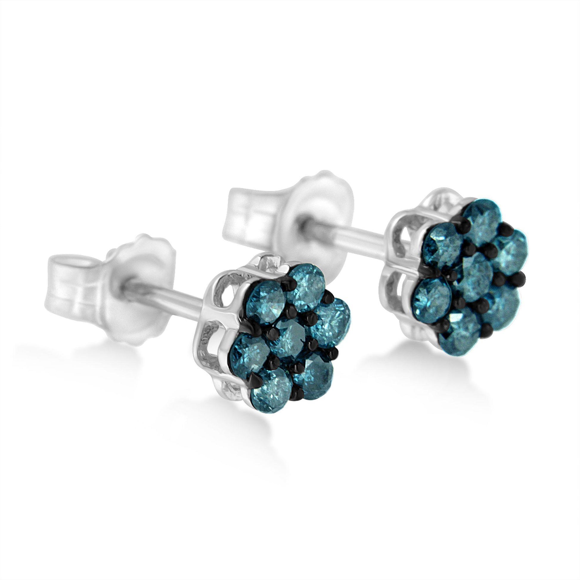 Close-up front-angle view of white metal stud earrings with round blue gemstones in prong settings arranged in a cluster.