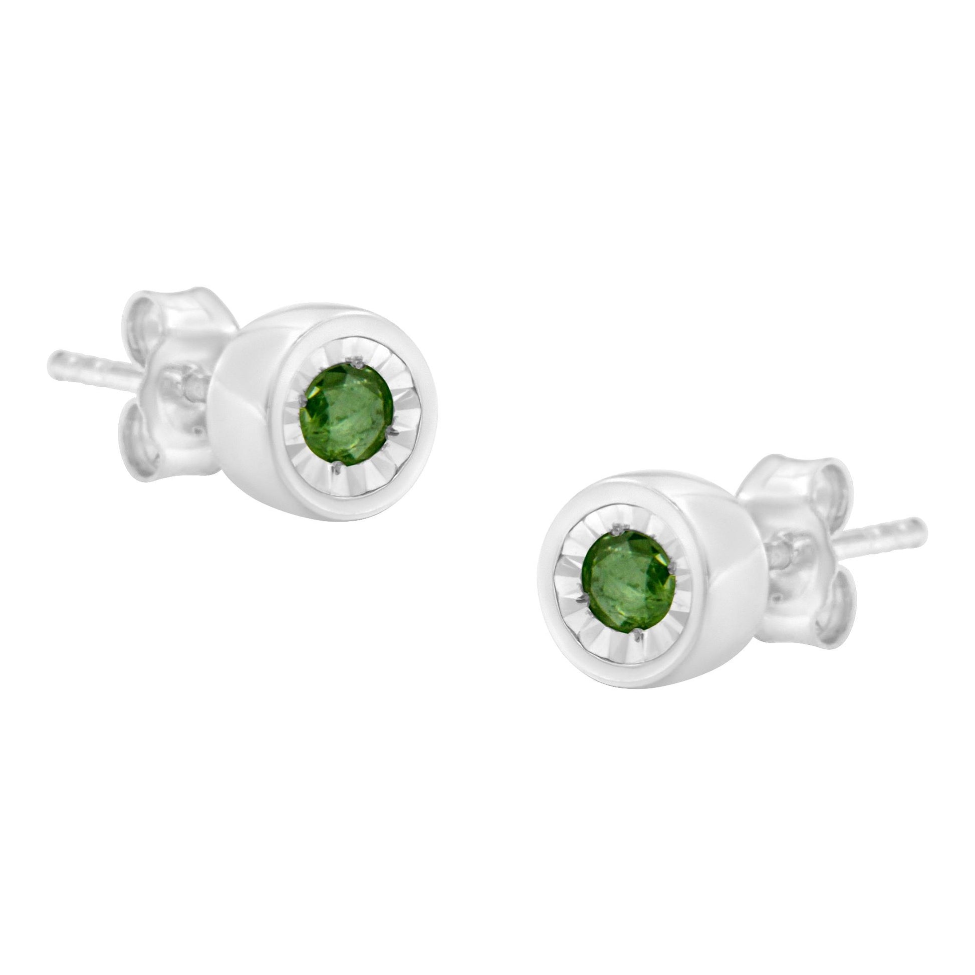 Close-up angled view of white metal stud earrings each featuring a round green gemstone in a miracle setting.