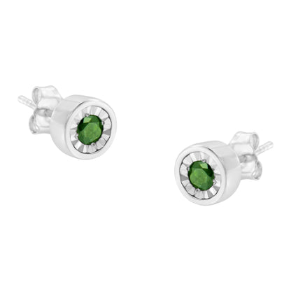 Pair of white metal stud earrings with round green gemstones in miracle settings, shown at a slight angle.