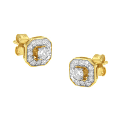 Pair of yellow metal stud earrings with a central round white gemstone in prong setting, surrounded by smaller round white gemstones in pave setting, shown from a front angle.