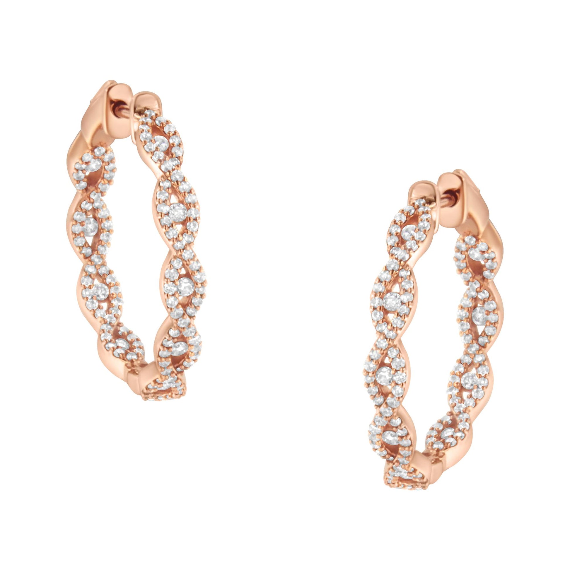 Close-up front angle of a pair of rose-colored metal hoop earrings with an infinity pattern accented by white round gemstones in prong settings.