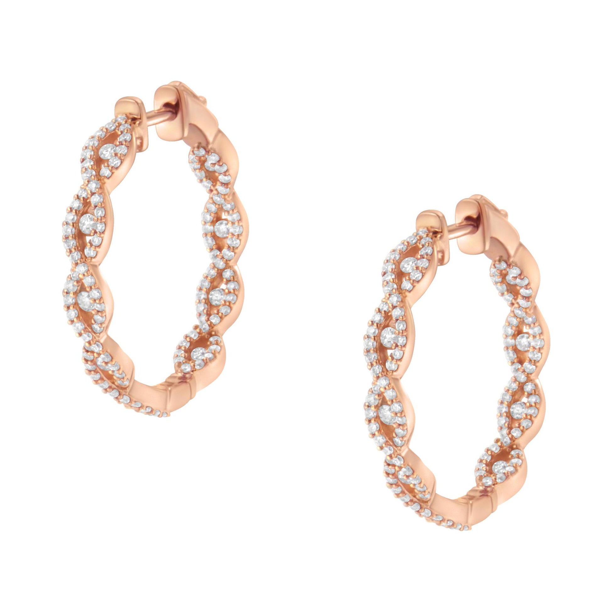 Pair of rose metal hoop earrings with twisted design, featuring round white gemstones in prong settings, shown in close-up front angle.