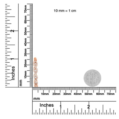 Close-up side view of a rose-colored metal earring with white round gemstones in prong settings, positioned next to rulers and a dime for size reference.