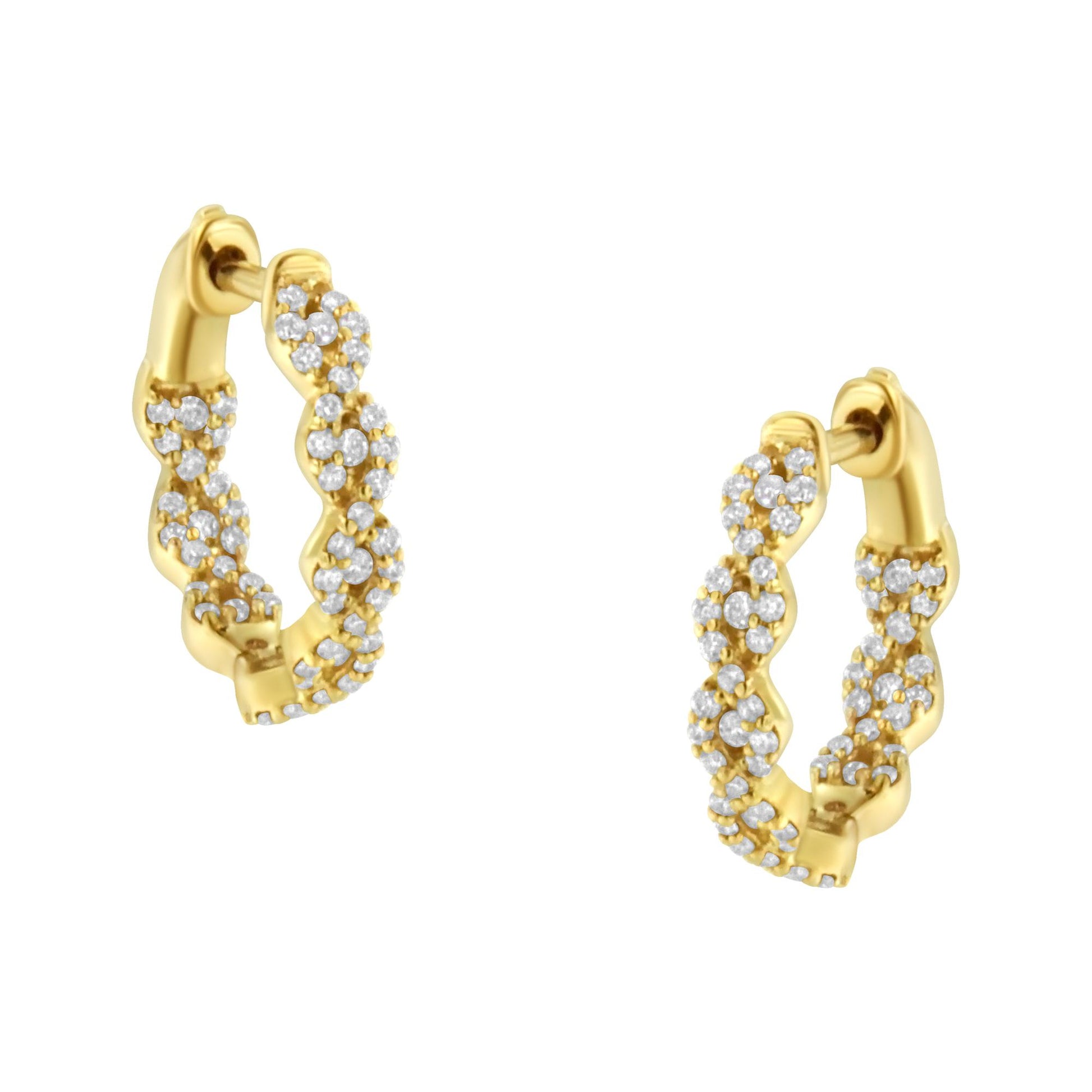 Pair of yellow metal hoop earrings with twisted design, adorned with multiple small white gemstones, shown at a slight angle.