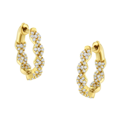 Pair of yellow metal hoop earrings with twisted design, adorned with multiple small white gemstones, shown at a slight angle.