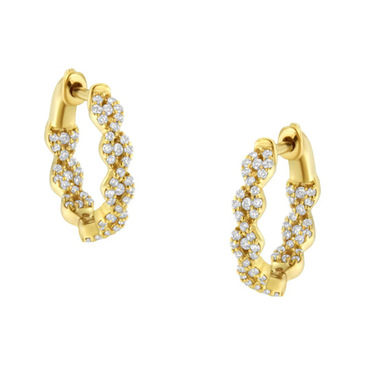 Pair of yellow metal hoop earrings with twisted design, adorned with multiple small white gemstones, shown at a slight angle.
