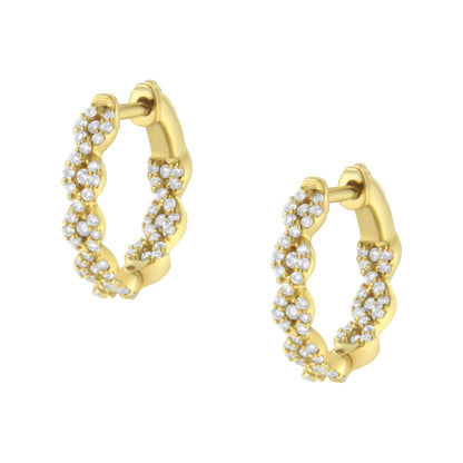 Close-up front angle of yellow metal hoop earrings with white round gemstones in prong settings arranged in a twisted design.