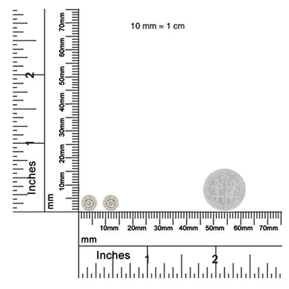 Pair of yellow metal stud earrings with round white gemstones in prong settings, shown on a ruler and scale for size reference, front-facing angle.